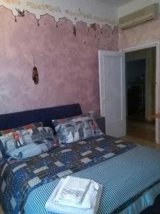 a bedroom with a bed with a blue comforter at Pegli The Artist's House, Seaside And Sun in Genoa