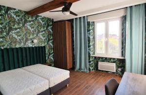 a bedroom with a white bed and a window at Luxurio rooms with baths in Livorno