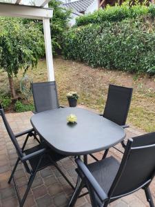 un patio con mesa y 4 sillas en Katjas Ferienwohnung, en Nittel