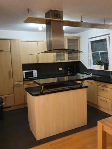 a kitchen with a stove top oven in a room at Katjas Ferienwohnung in Nittel