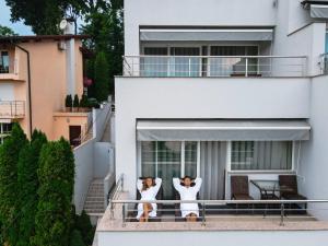2 chiens debout sur le balcon d'une maison dans l'établissement Wellness Hotel Villa Magdalena, à Krapinske Toplice