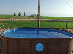 a hot tub in the middle of a field at Casa La Tora in Deltebre