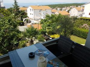 a table and chairs on a balcony with a view at Villa Jeka, Malinska, Krk in Malinska