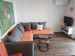 a living room with a couch and a tv at Villa Jeka, Malinska, Krk in Malinska