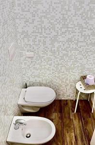 a bathroom with a toilet and a sink at Via ROMA 145 in Santeramo in Colle