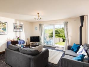 a living room with two couches and a tv at Nectan in St Austell