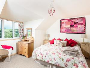 a bedroom with a bed and a dresser and a mirror at Nectan in St Austell