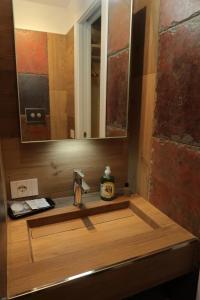 a bathroom counter with a sink and a mirror at Michele Guest House in Pisa