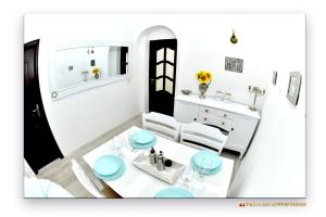 a small kitchen with a white table and chairs at Casa Fotografului in Constanţa +71 photos