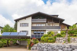 a house with solar panels on top of it at Försterhaus Wohnung Obergeschoss in Egg