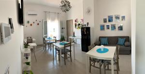 a living room with tables and chairs and a couch at L’Angolo Chiaro in Taviano