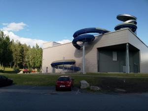 a red car parked in front of a building at Finnclub Voyage Luxury Appartment in Laukaa