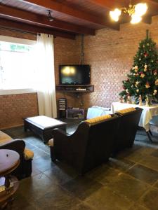 a living room with a christmas tree and a couch at Chácara Recanto in Bragança Paulista