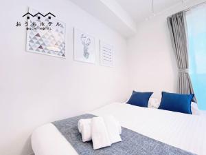 Postel nebo postele na pokoji v ubytování OUCHI HOTEL Miyajimaguchi