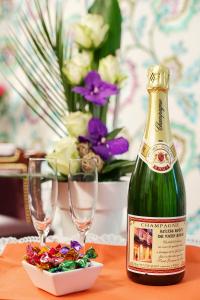 a bottle of champagne sitting on a table with glasses at Relais Hôtel du Vieux Paris in Paris