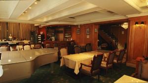a restaurant with tables and chairs in a room at Meadow Hotel Taipei in Taipei