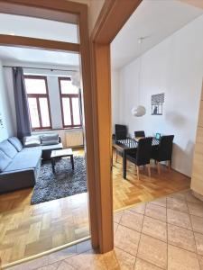 a living room with a blue couch and a table at Gozsdu Apartment in Budapest