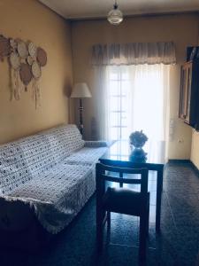 1 dormitorio con cama, mesa y ventana en Apartamento Valle del Medio, en San Vicente de Alcántara