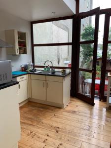 a kitchen with a sink and a large window at Hygge Vakantiewoning in Ostend