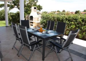 czarny stół i krzesła na patio w obiekcie Sunwell apartments - Novalja, Gajac, Zrće w Novalji