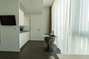 TV a/nebo společenská místnost v ubytování Los Lorentes Hotel Bern Airport