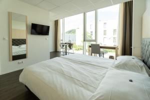 Postel nebo postele na pokoji v ubytování Los Lorentes Hotel Bern Airport