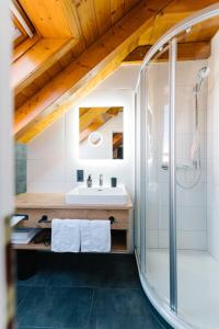 a bathroom with a sink and a shower at Moderne 2 Zi.-FeWo BlackForestArt Nähe Freiburg in Simonswald