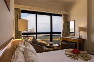 a hotel room with a bed and a large window at Plaza Hotel Alexandria in Alexandria