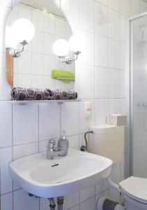 Oberthulba的住宿－希爾啤酒坊，白色的浴室设有水槽和卫生间。