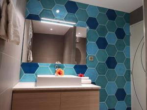 a bathroom with a white sink and blue tiles at Résidence Cantu di Mare in Olmeto +101 photos