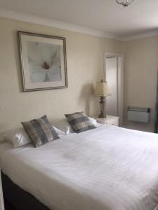 A bed or beds in a room at Barbon Inn