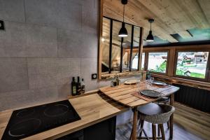 a kitchen with a wooden counter top in a room at Studio Lessy - Centre village - AravisTour in Saint-Jean-de-Sixt