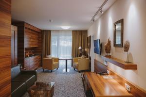 a living room with a couch and a table at Hotel Süd Graz in Graz