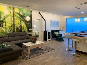 a living room with a couch and a table at Holiday Apartment Sunset Ocean in Ribeira Brava