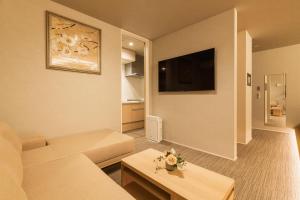 a living room with a couch and a table at GRAND BASE Hakata Station in Fukuoka