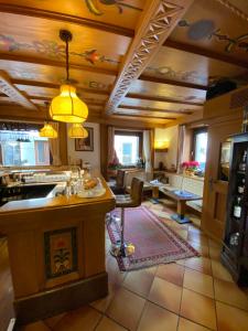 a kitchen and living room with a bar in a house at Folgaria Post Hotel in Folgaria