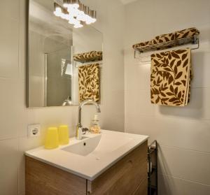 a bathroom with a sink and a mirror at Apartamentos Casa María in Cala Figuera +41 photos