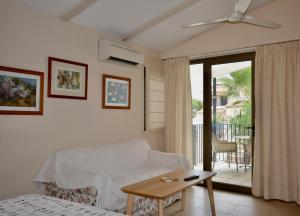 a living room with a white couch and a table at Apartamentos Casa María in Cala Figuera