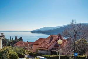 a house with a view of a lake at Apartmani Škopac Rabac in Rabac