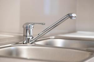 a kitchen sink with a silver faucet at ONITES Elegant Suites in Skala Potamias