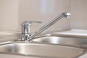 a kitchen sink with a silver faucet at ONITES Elegant Suites in Skala Potamias +76 photos
