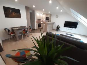 a living room with a couch and a dining room at Apartmány Viecha in Bardejov