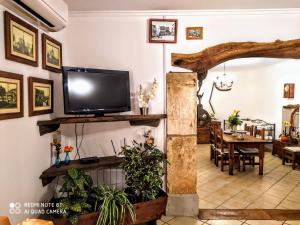 a living room with a television and a dining room at Ca na Maria in Manacor