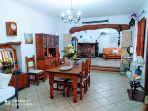 a living room with a table and chairs and a fireplace at Ca na Maria in Manacor