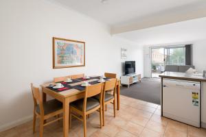 a kitchen and dining room with a table and chairs at Bayview Apartments by Classic Holidays in Cowes