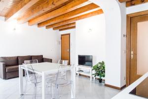 a white dining room with a white table and chairs at INTERO APPARTAMENTO nel cuore di VICENZA in Vicenza
