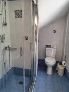 a bathroom with a toilet and a glass shower at Stoupa Lefktro 5 in Stoupa