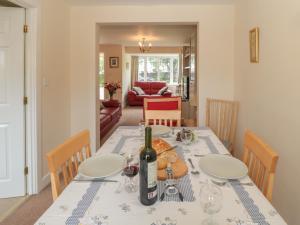 a dining room table with a bottle of wine on it at 3 Kings Field in Seahouses