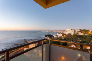 a view from the balcony of a balcony overlooking the ocean at Hotel Estoril Eden in Estoril