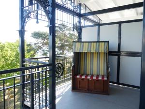 a chair on the balcony of a building at Villa Strandblick in Binz